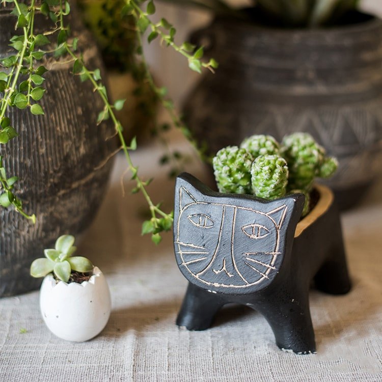 Cat-shaped concrete planter, black with etched face by RusticReach, holds succulents on Tampa Home & Garden Store