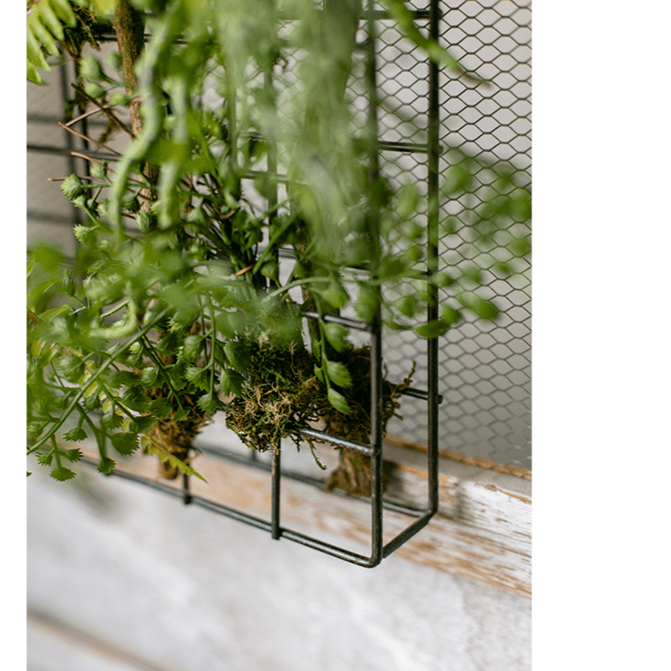 Artificial faux plant in a metal frame wall decor with green leafy mesh grid on Tampa Home & Garden Store