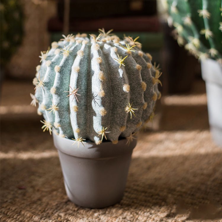 Artificial faux cactus ball in a gray pot with ribbed blue-green body and yellow spines on Tampa Home & Garden Store