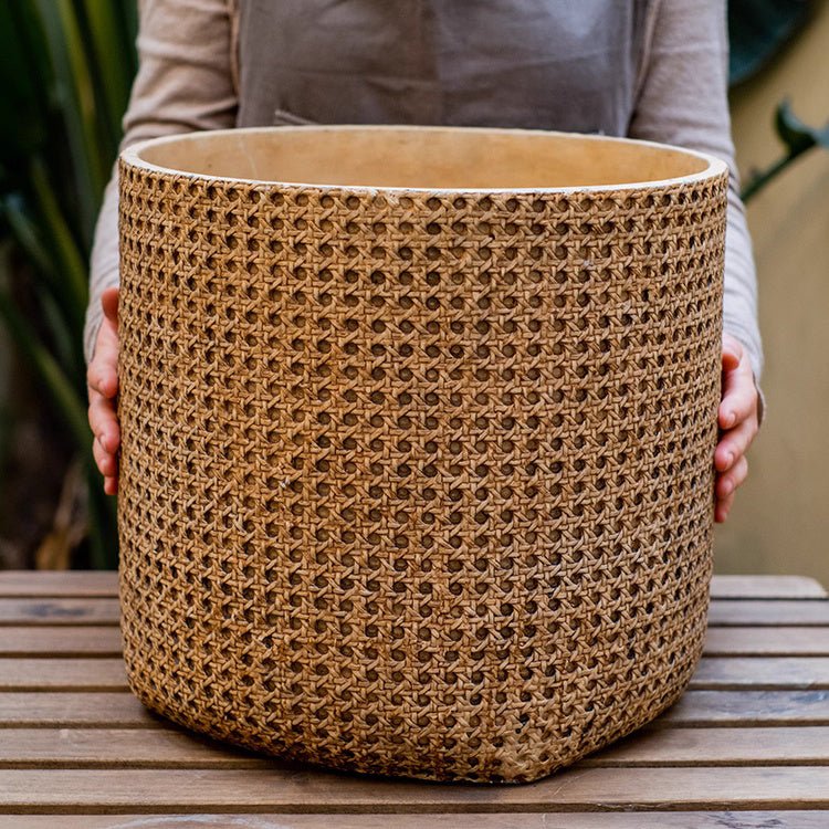 Rattan Texture Cement Planter RusticReach, cylindrical woven tan planter held on a table on Tampa Home & Garden Store