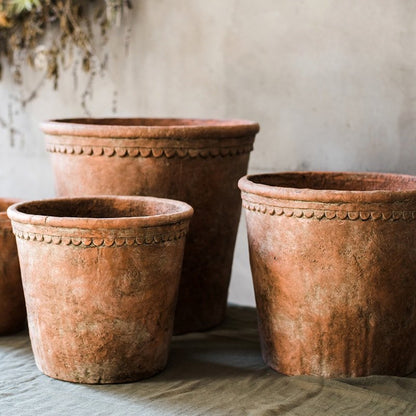 Large terracotta red concrete planters set of three with decorative beaded rims on Tampa Home & Garden Store