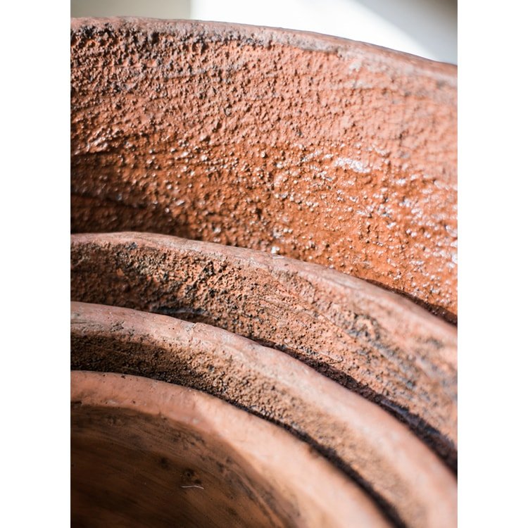 Stacked large terracotta red concrete planter pots by RusticReach with textured surfaces on Tampa Home & Garden Store