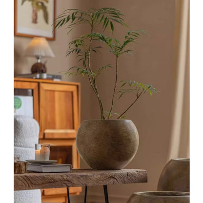 Round Magnesium Clay Planter RusticReach with earthy gray finish on a wooden table on Tampa Home & Garden Store