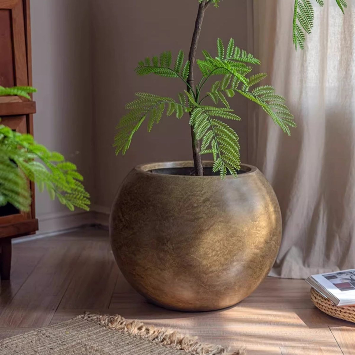 Round magnesium clay planter in warm metallic gold with a fern, RusticReach on Tampa Home & Garden Store