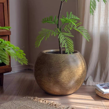 Round magnesium clay planter in warm metallic gold with a fern, RusticReach on Tampa Home & Garden Store