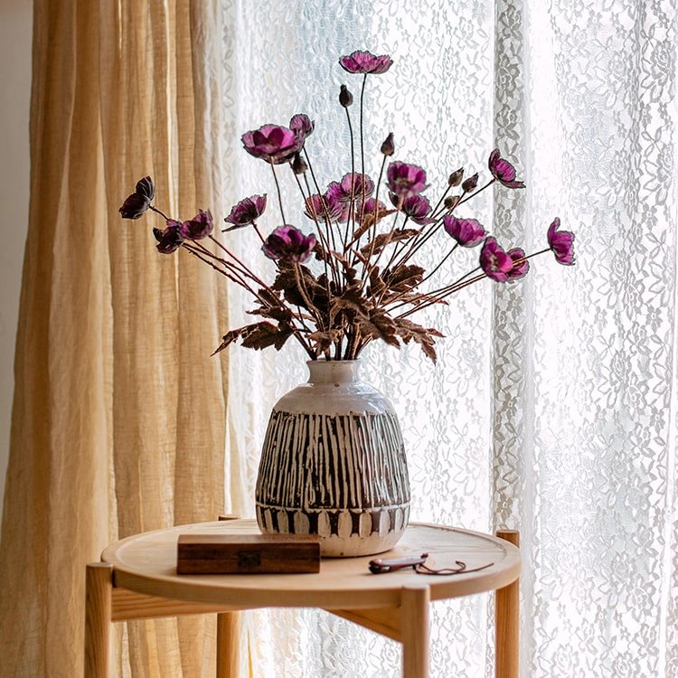 Faux Silk Rustic Poppy Flower Stems in Purple in a striped ceramic vase on a round wood table on Tampa Home & Garden Store