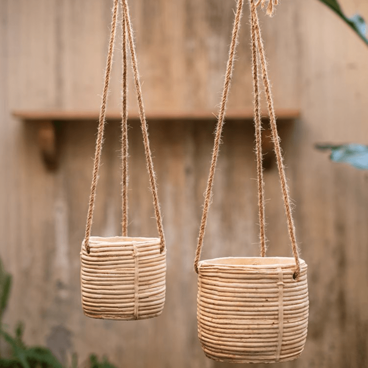 Faux rattan cement hanging planters by RusticReach, two beige woven pots with jute hangers on Tampa Home & Garden Store