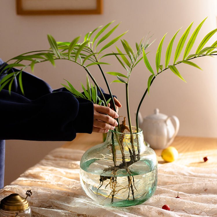 RusticReach faux rooted Murdannia leaf arrangement, 23 inches tall, in a round glass vase with water on Tampa Home & Garden Store