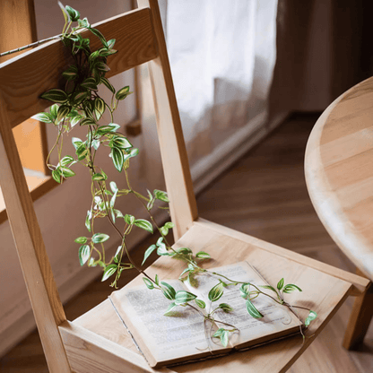 Artificial Small Leaf Vine 40-inch long variegated leaves draped over a chair RusticReach on Tampa Home & Garden Store
