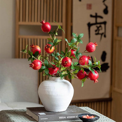 Faux Short Pomegranate Stem 15 in Tall with red pomegranates and green leaves in white vase on Tampa Home & Garden Store