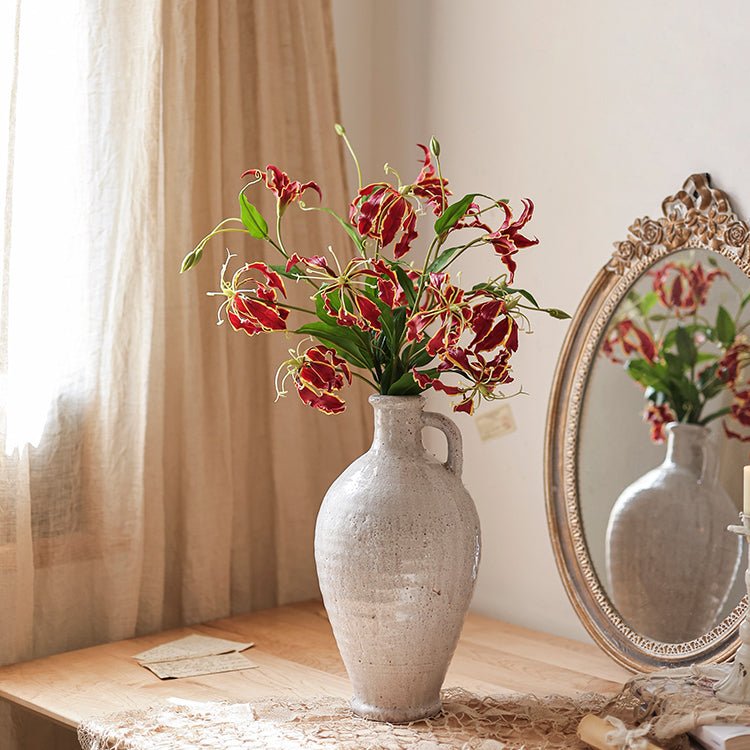 Faux Silk Flame Lily Stem, 29in tall with red and cream blooms and green leaves in a speckled gray ceramic vase on Tampa Home & Garden Store
