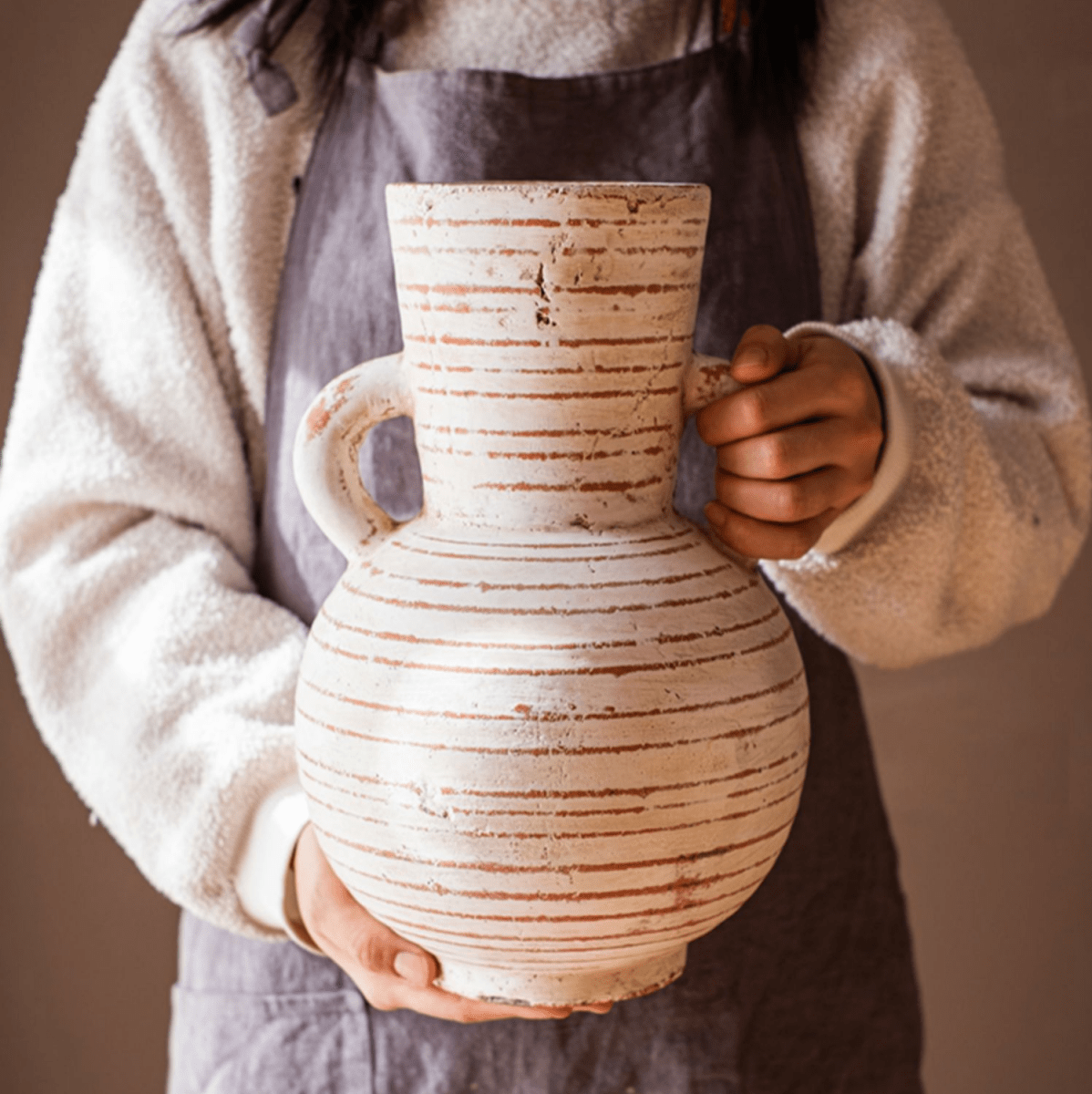 Terracotta Planter Vase with Handles, white with rustic brown stripes, held by a person on Tampa Home & Garden Store