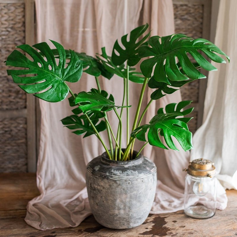 Artificial Turtle Leaf Stem Bunch with green glossy Monstera leaves in a rustic gray pot on Tampa Home & Garden Store
