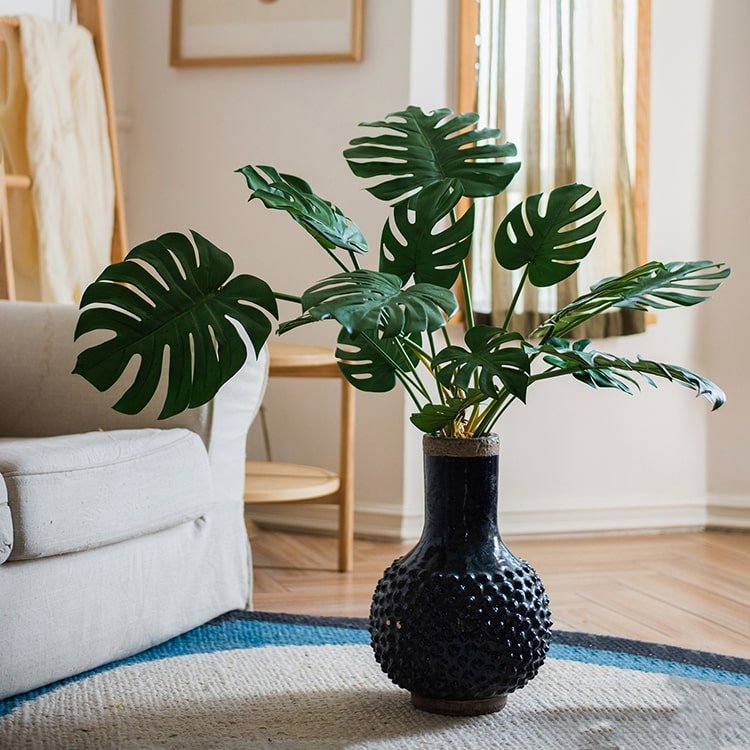 Artificial Turtle Leaf Stem Bunch by RusticReach with Monstera leaves in a black textured vase on Tampa Home & Garden Store