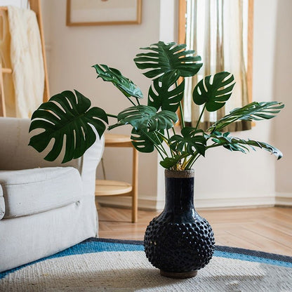 Artificial Turtle Leaf Stem Bunch by RusticReach with Monstera leaves in a black textured vase on Tampa Home & Garden Store