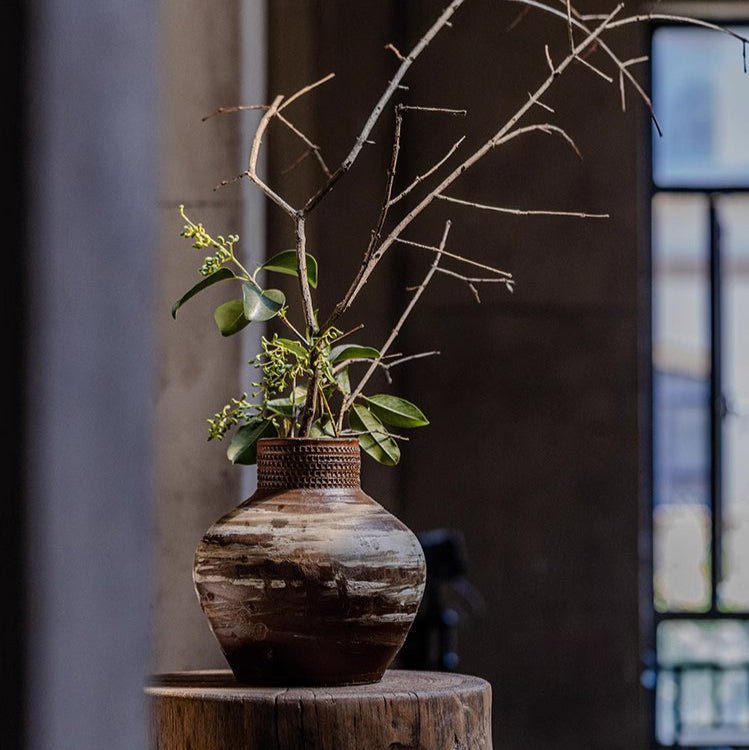 Vintage Wabi-Sabi Ceramic Jar vase with brown glaze on a wood stump with branches on Tampa Home & Garden Store