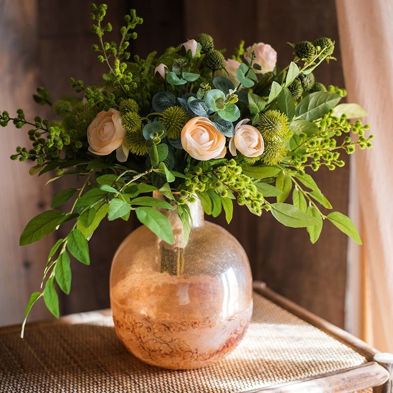 Hand blown bubble glass bud vase in amber with peach roses and lush greenery on Tampa Home & Garden Store