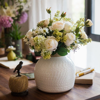 White glazed ceramic vase with cream roses and greenery on a wooden table on Tampa Home & Garden Store