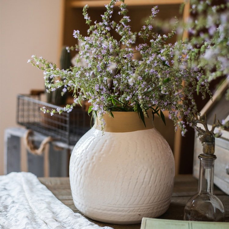 White glazed ceramic vase by RusticReach with tan neck, filled with purple flowers on Tampa Home & Garden Store