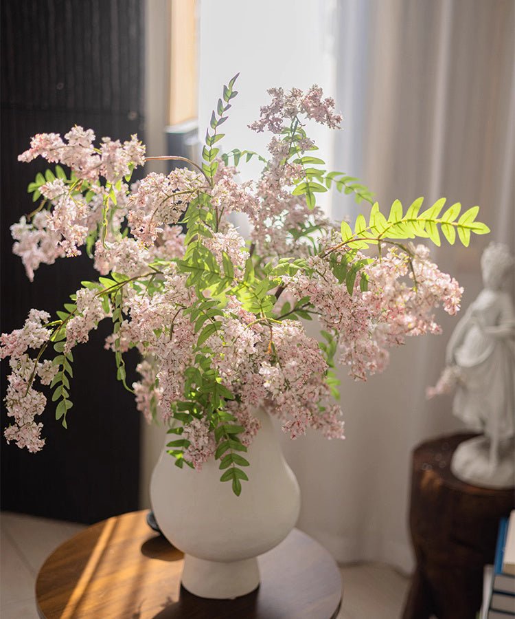 Enchanted Garden Wisteria Stem, 51in faux plant with pink blooms and green leaves in white vase on Tampa Home & Garden Store