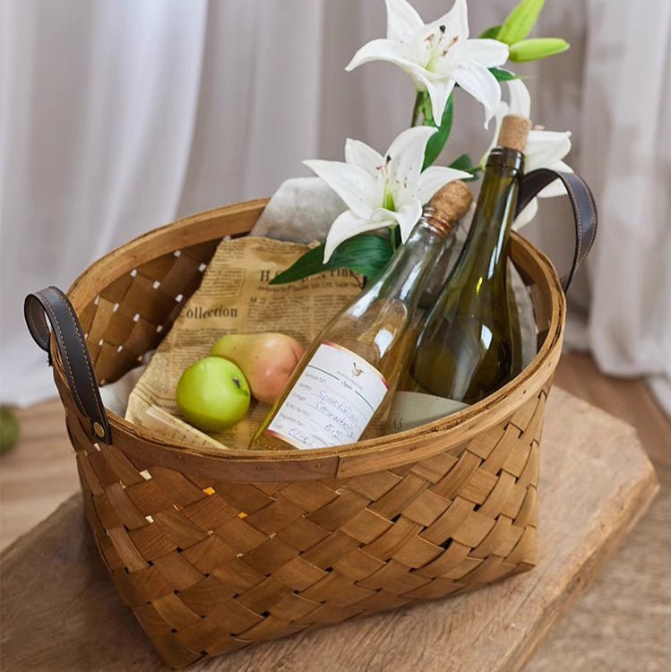 Rustic Handwoven Woodchip Basket by RusticReach with handles, holding wine bottles and lilies on Tampa Home & Garden Store