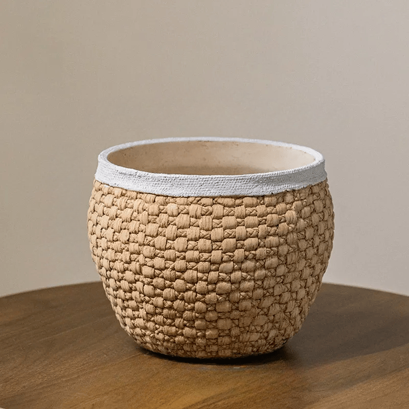 Woven rattan cement planter by RusticReach with tan weave and grey rim on a wooden table on Tampa Home & Garden Store