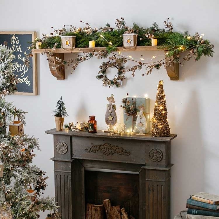 Christmas Rattan Cone Tree in Gold by RusticReach on a mantel with garland and candles on Tampa Home & Garden Store