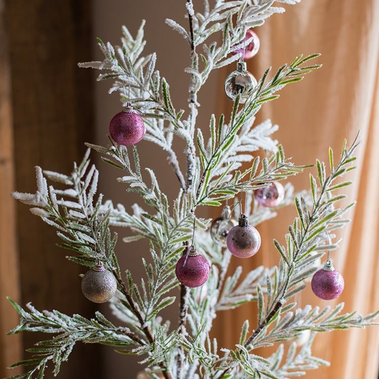 Cedar Fir Snow Flocked Christmas Tree by RusticReach with pink ornaments paper wrapped base on Tampa Home & Garden Store