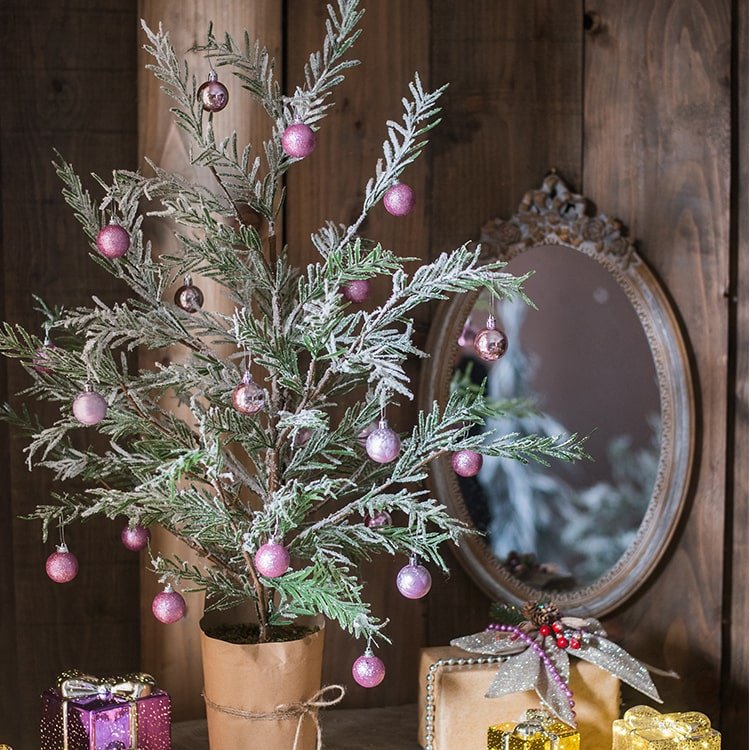 Cedar Fir Snow-Flocked Christmas Tree in paper-wrapped base with pink ornament balls on Tampa Home & Garden Store