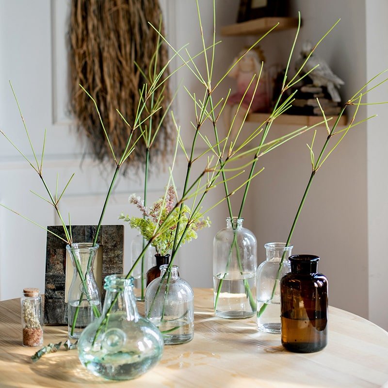 Artificial Zen Style Bamboo Stem 30-inch tall with multiple green stalks in clear glass bottles on a wooden table on Tampa Home & Garden Store