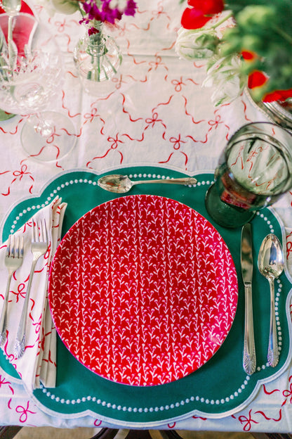 Cranberry Ivy Manor china plates, red patterned on teal placemat with silverware on Tampa Home & Garden Store