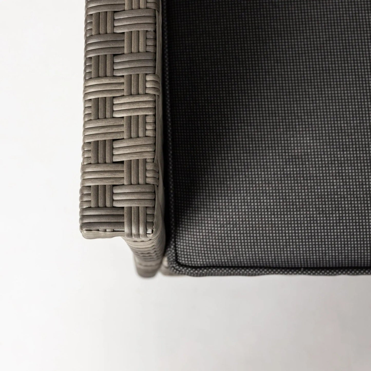 Jareth Wicker Patio Set armrest detail in taupe woven wicker with dark gray cushion on Tampa Home & Garden Store