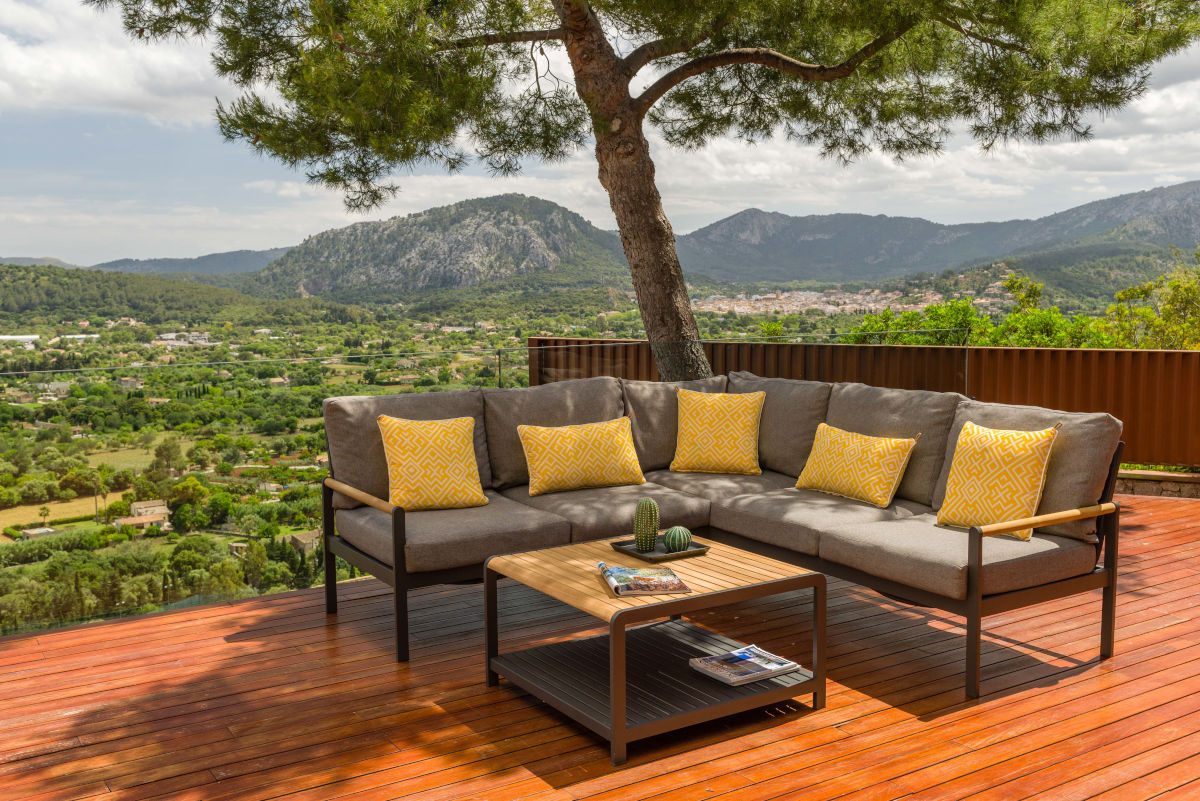 Amber Sectional Coffee Set with grey cushions and yellow pillows on a dark metal framed balcony sofa on Tampa Home & Garden Store