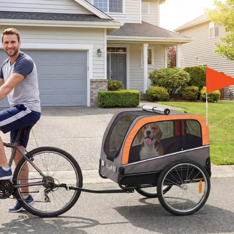 Dog bike trailer with orange/gray panels, 20in air tires and flag hitched to a bicycle on Tampa Home & Garden Store