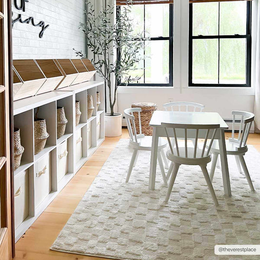 Keesa Checkered Area Rug by Boutique Rugs in white checkered pattern under a white dining table on Tampa Home & Garden Store