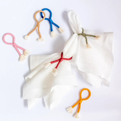 Nautical knot napkin ring set of 4 in pink, peach, blue and orange with tassels on white napkins on Tampa Home & Garden Store