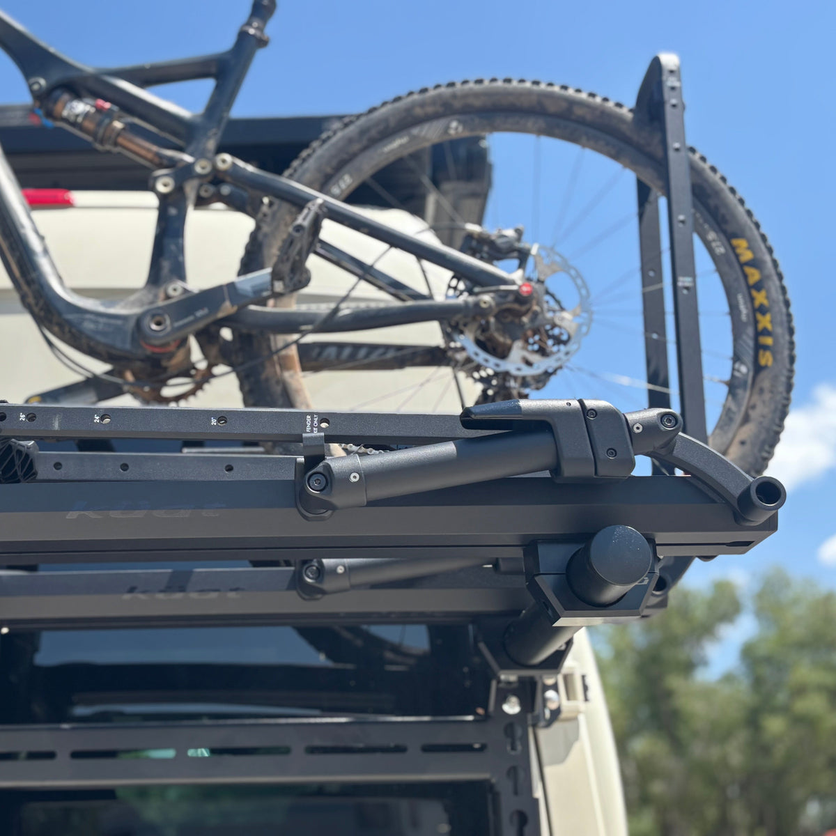 Bike Posts for Massif mount on a black vehicle roof rack with a full-suspension mountain bike on Tampa Home & Garden Store