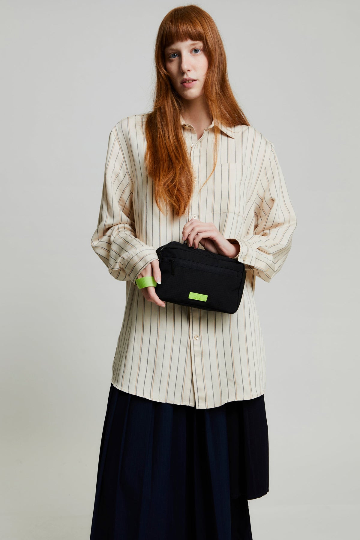Kei Lithe Washbag Black Lime Vandra by Lefrik USA with neon lime accent held by model on Tampa Home & Garden Store