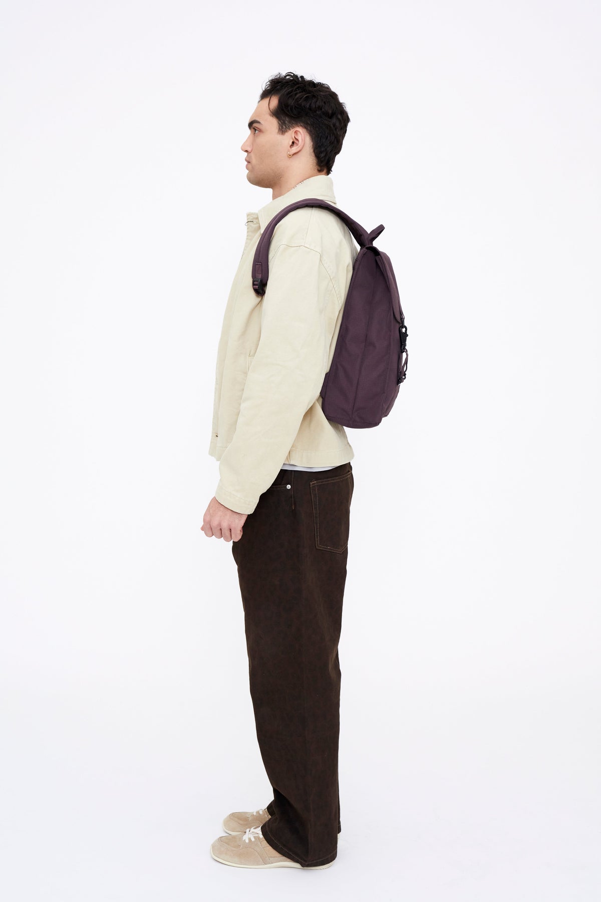 Handy XL Backpack With Laptop Sleeve in purple worn by man in beige jacket on Tampa Home & Garden Store
