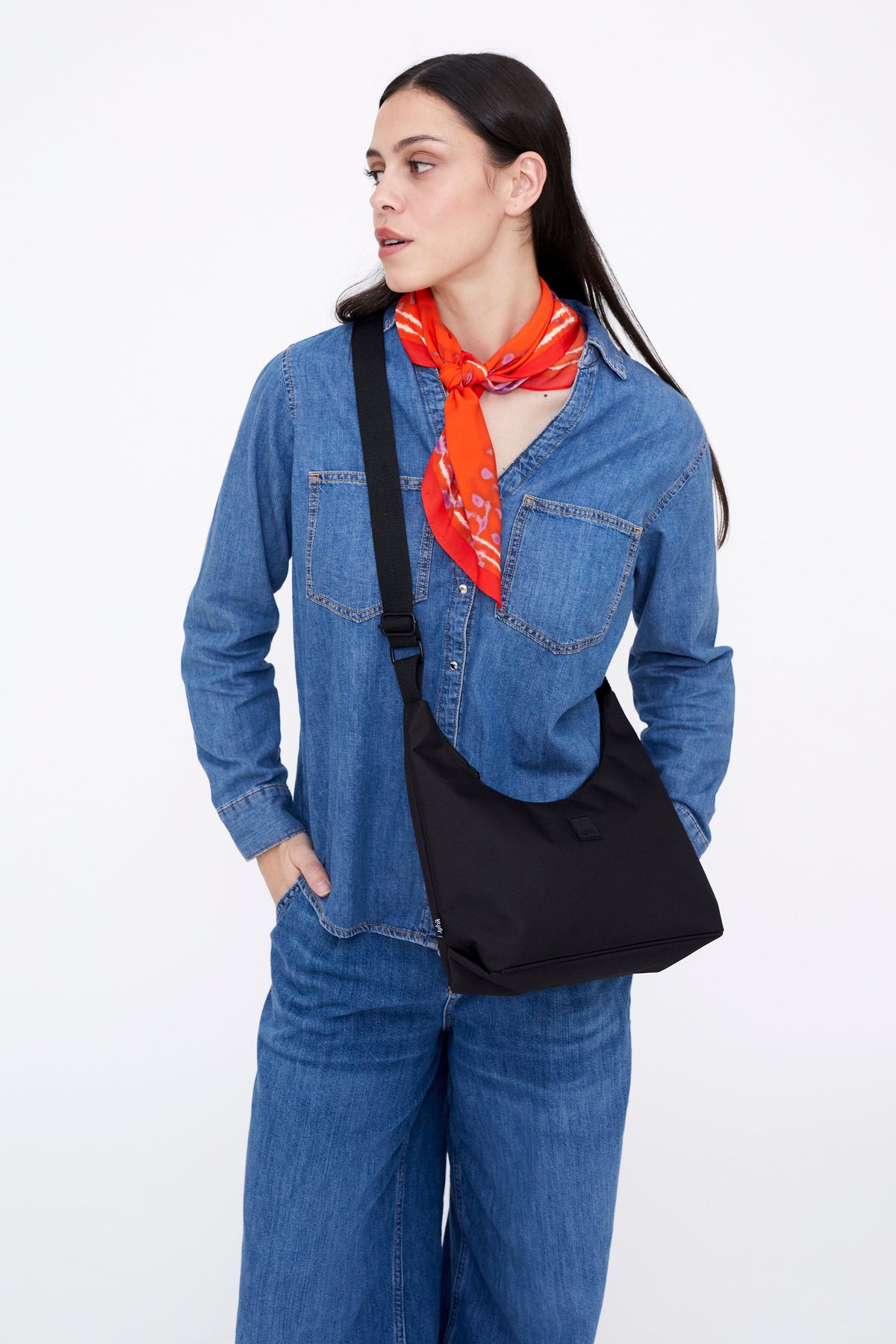 Bico Bag black crescent mini bag with crossbody strap Lefrik USA worn by model in denim shirt on Tampa Home & Garden Store