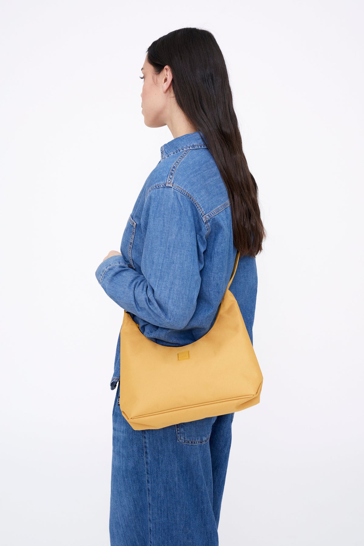 Bico Bag in Mustard with Crescent Silhouette Lefrik USA mustard handbag worn over shoulder on Tampa Home & Garden Store