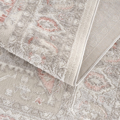 Damla Area Rug plush beige gray pile with pink accents, folded edge shows backing on Tampa Home & Garden Store