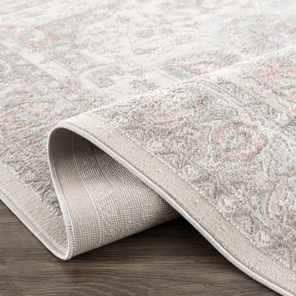 Three Boutique Rugs Damla Area Rug beige-gray with pink accents, plush pile, rolled for display on Tampa Home & Garden Store