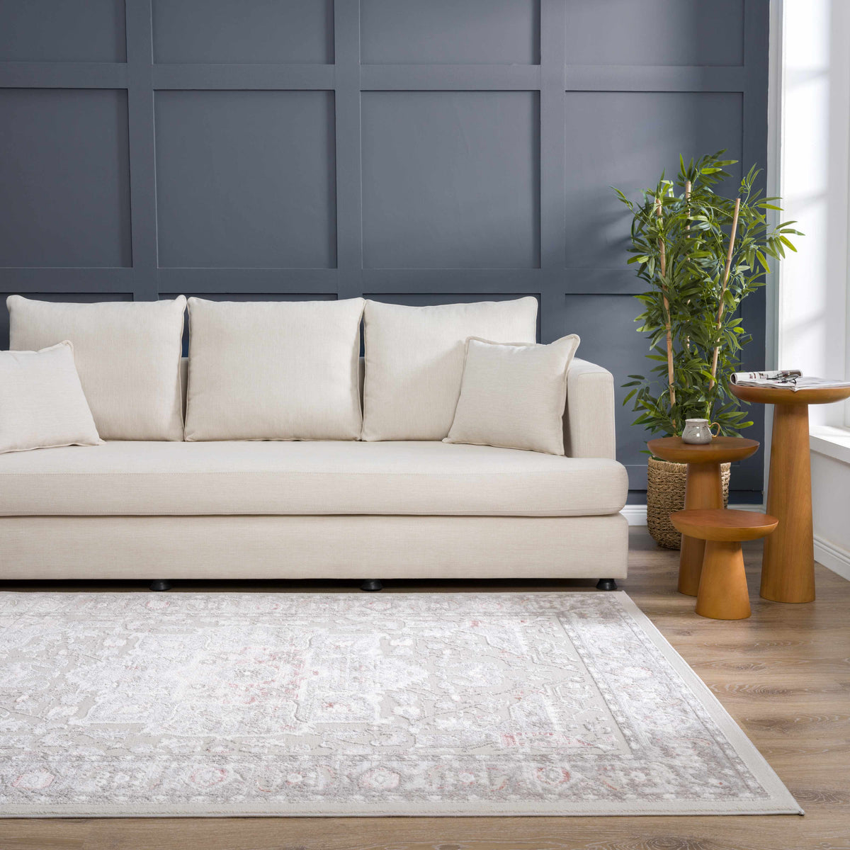 Damla Area Rug by Boutique Rugs, ivory cream with subtle gray pattern in a living room setting on Tampa Home & Garden Store