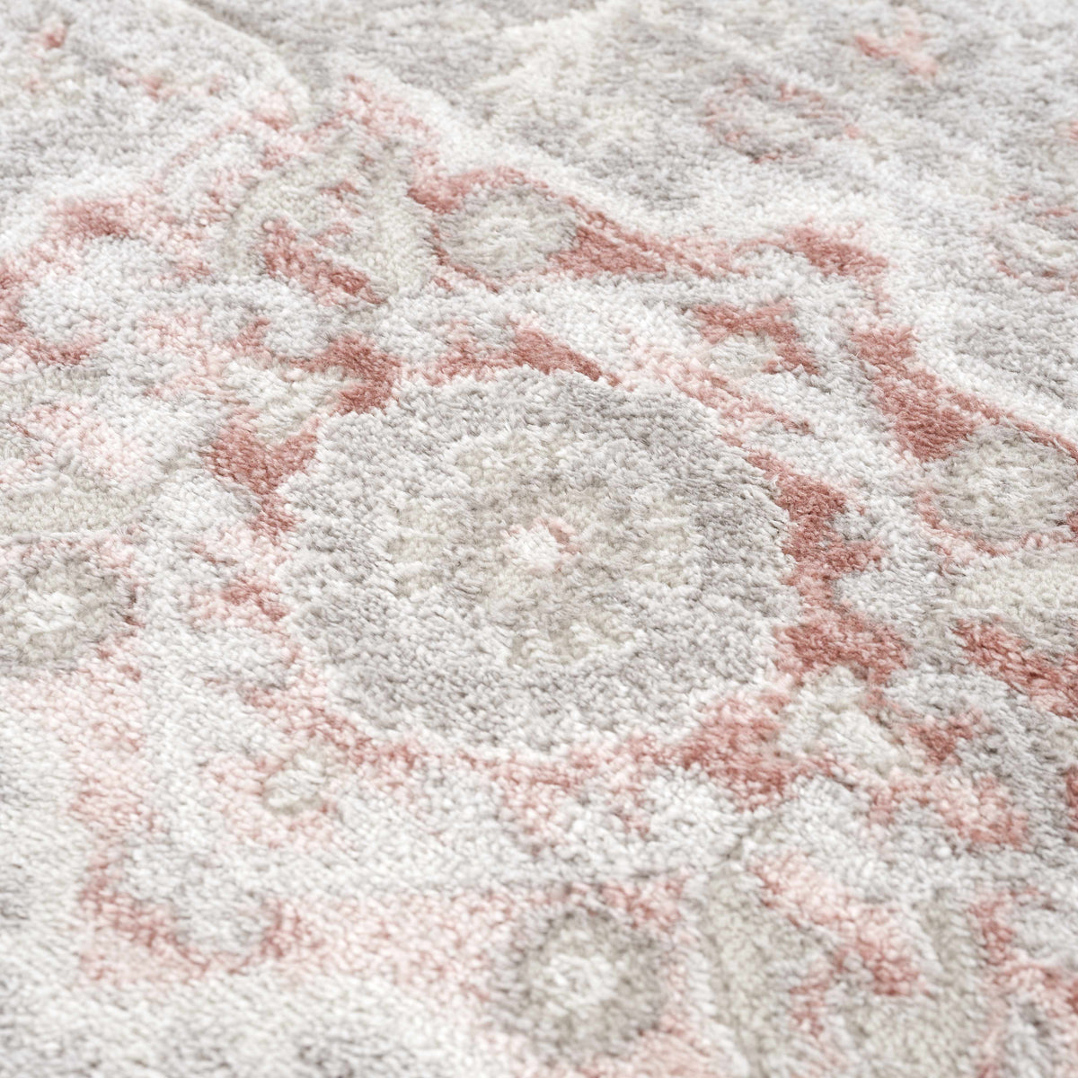 Damla area rug by Boutique Rugs in soft gray and pink tones with plush pile on Tampa Home & Garden Store