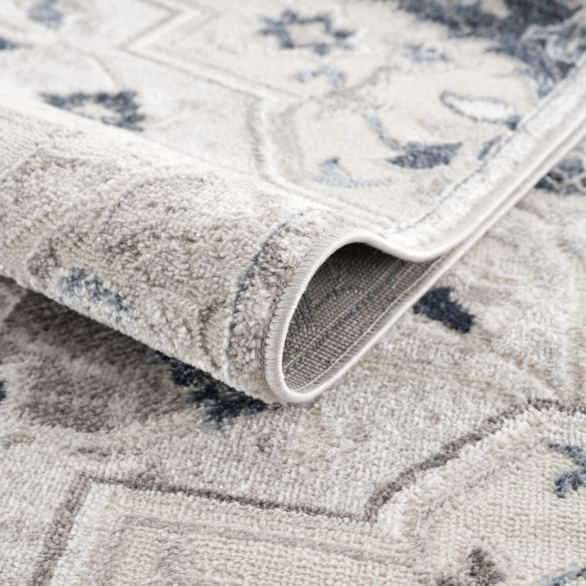 Calum Blue & Gray Area Rug, plush beige pile with blue-gray pattern, folded edge on Tampa Home & Garden Store