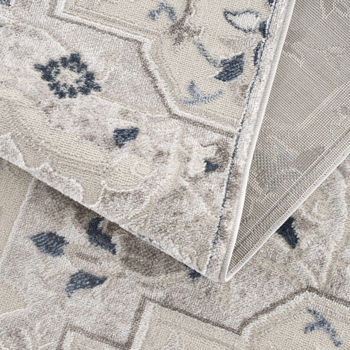 Calum blue & gray area rug beige backdrop with blue floral accents, bound edges on Tampa Home & Garden Store