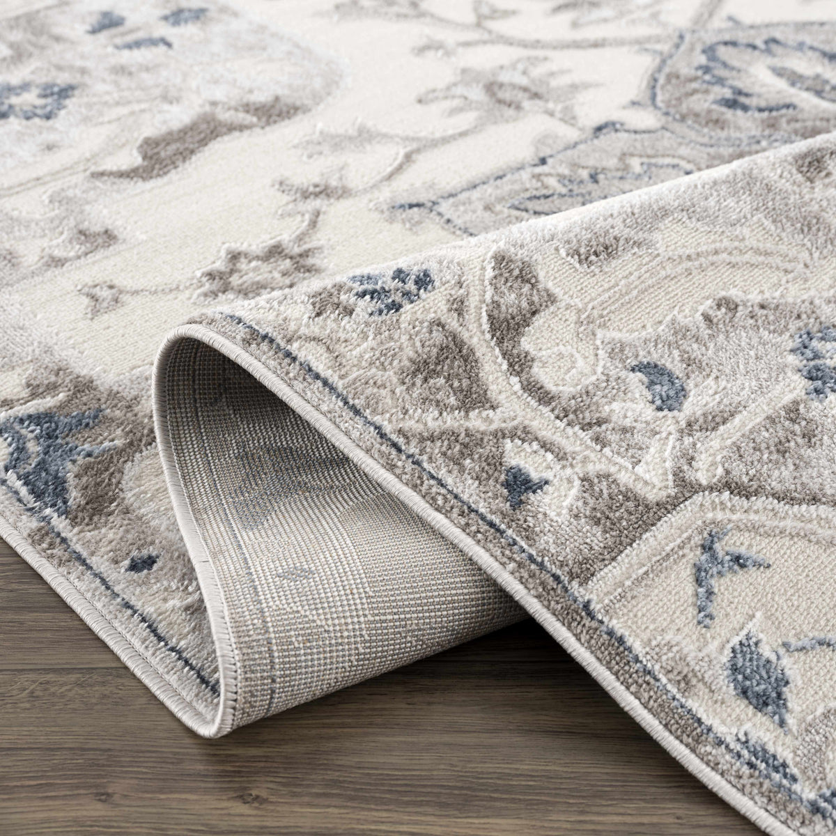 Calum blue gray area rug by Boutique Rugs, beige pattern with rolled edges on Tampa Home & Garden Store