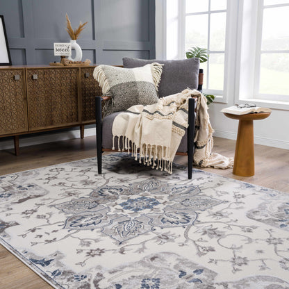 Calum blue and gray area rug by Boutique Rugs, ornate floral pattern on light background on Tampa Home & Garden Store