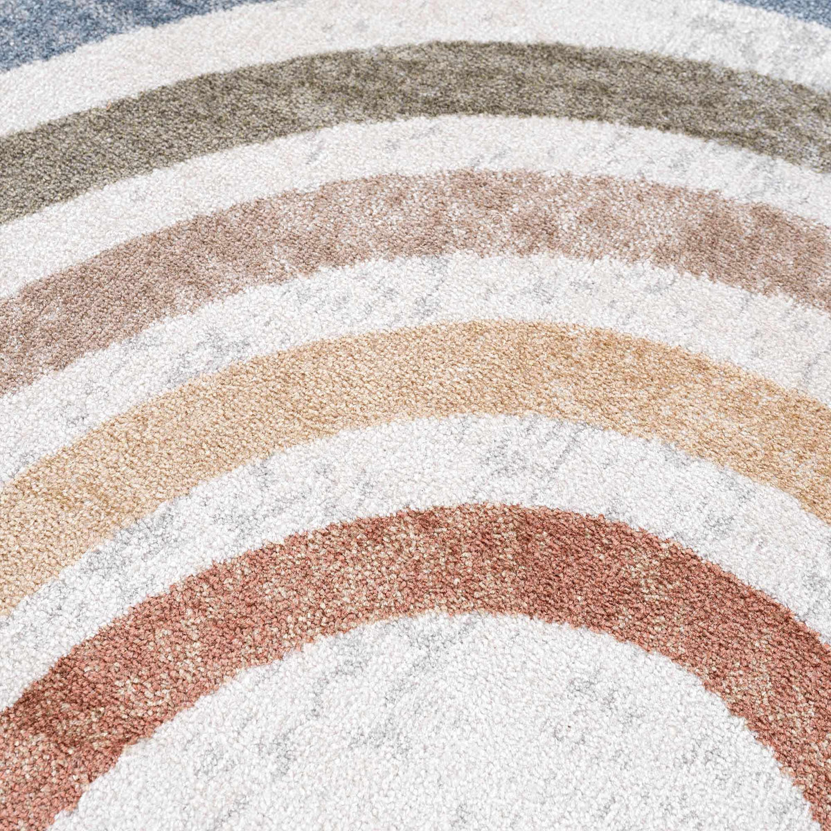 Giza washable area rug with multicolor curved stripes in blue, cream, taupe, beige, and brown on Tampa Home & Garden Store